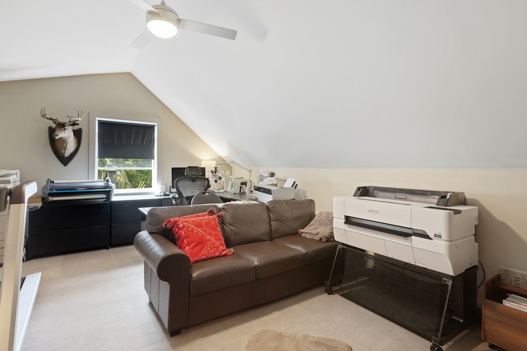 Servicios inmobiliarios Arucas Las Palmas. a-living-room-with-a-couch-and-a-printer-8vnrpkh61js